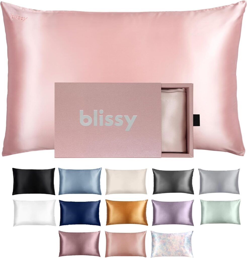 Pink silk sleep mask and matching pillowcase folded neatly