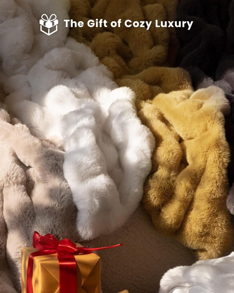 Soft neutral‑colored plush throw blanket draped over a couch